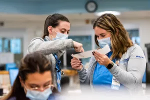 Two nurses in the Critical Care Unit reviewing data. 