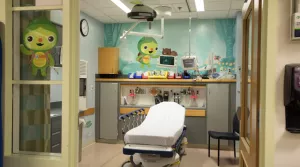 Pediatric emergency department room with illustrations of Toughlings on the walls and window