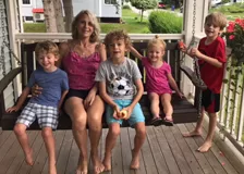 Katherine Fitzpatrick with her grandchildren on her porch swing