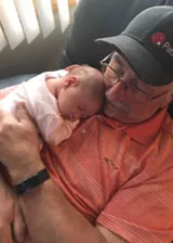Pat with a baby in his lap